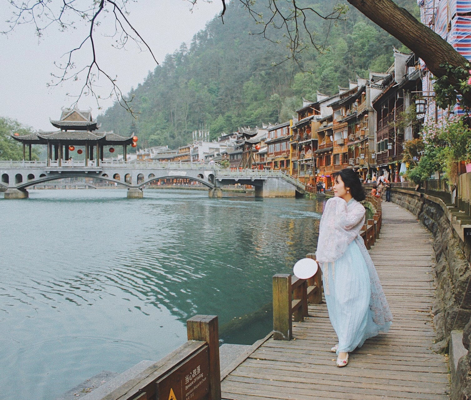 A tourist poses for a photo while taking a tour to China. Photo: Thu Ha