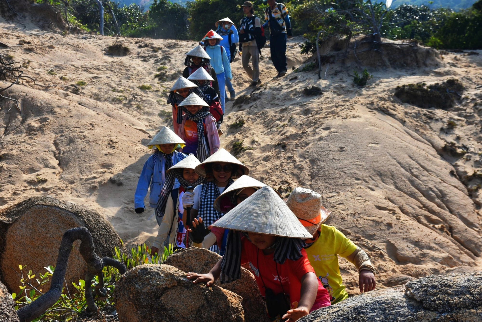 A group of tourists trek through a sand dune to reach Doi Cape, Van Ninh District, Khanh Hoa Province, central Vietnam. Photo: Tran Hoai