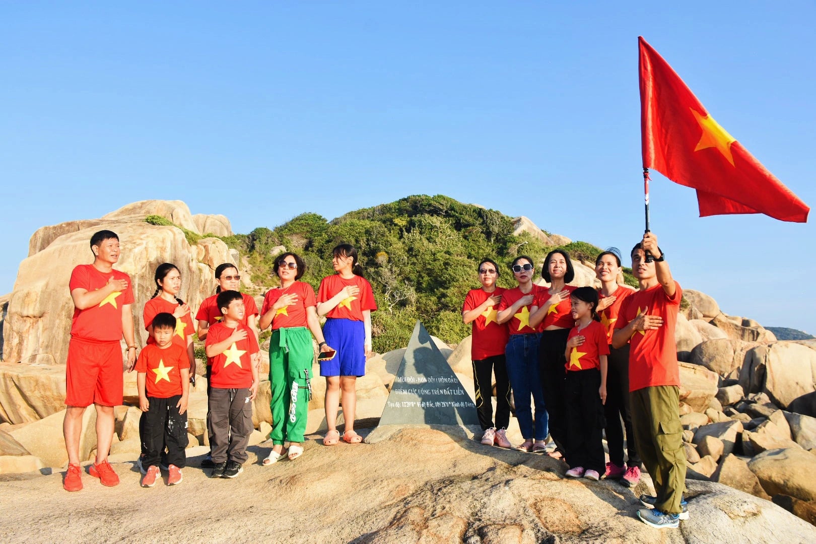 A group of tourists pose for a photo at the landmark at Doi Cape. Photo: Tran Hoai
