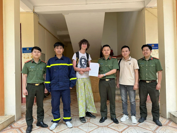Henwood Joseph Thomas (L, 3rd), is seen showing his thank-you letter when posing for a photo with Vietnamese rescuers on April 20, 2024 after he was saved from getting lost in the Hoang Lien National Park, located in Lai Chau and Lao Cai Provinces, northern Vietnam. Photo: Lai Chau public security department
