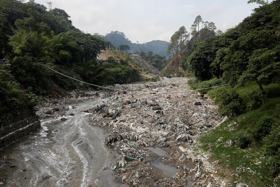 Garbage and plastic bottles float on Las Vacas river considered one of the most polluted rivers in the world, in the municipality of Chinautla, where the Ocean Cleanup NGO is testing a device to contain the garbage that ends up in the Atlantic Ocean, in Guatemala City , Guatemala June 8, 2022.