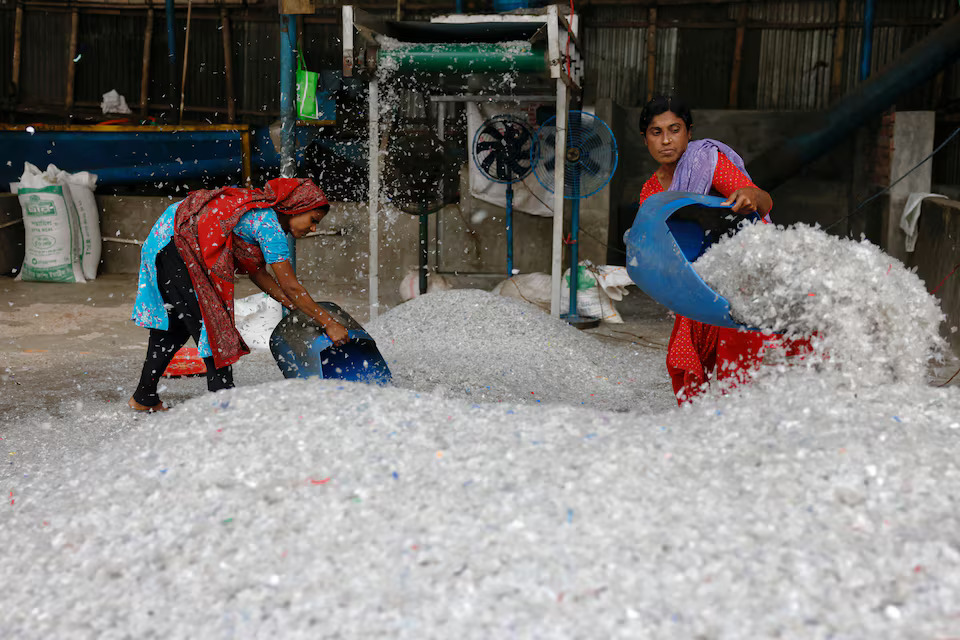 Women work in a plastic bottle recycling factory in Dhaka, Bangladesh, February 20, 2024. Photo: Reuters