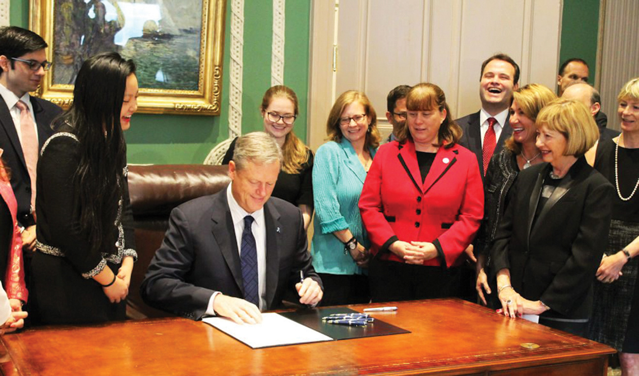 Then Massachusetts Governor Charlie Baker signs extending the preservation times of rape kits with Amanda Nguyen to his left in 2016. Photo: NBC News