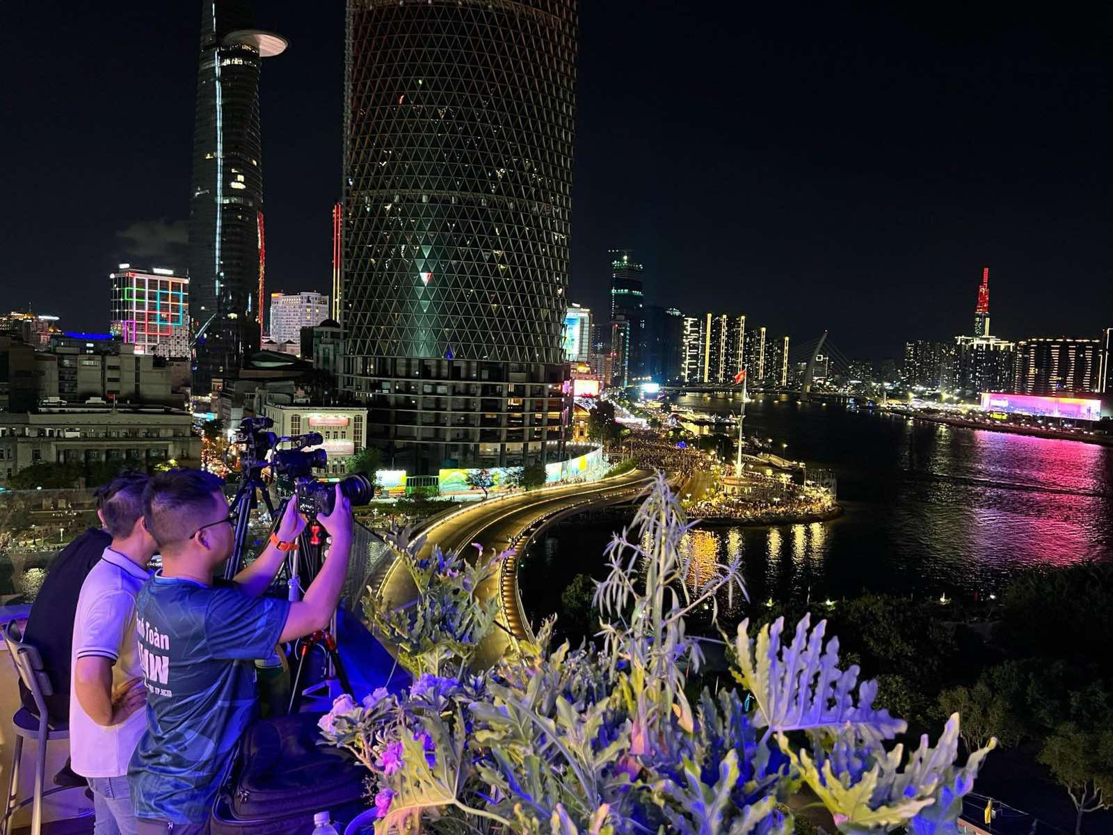 Several men take photos of a drone light show, Ho Chi Minh City, April 30, 2024. Photo: Duyen Phan / Tuoi Tre