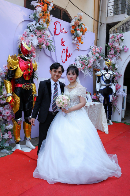 Duc and his wife at their wedding festooned with some superhero robots in late April 2024. Photo: Supplied