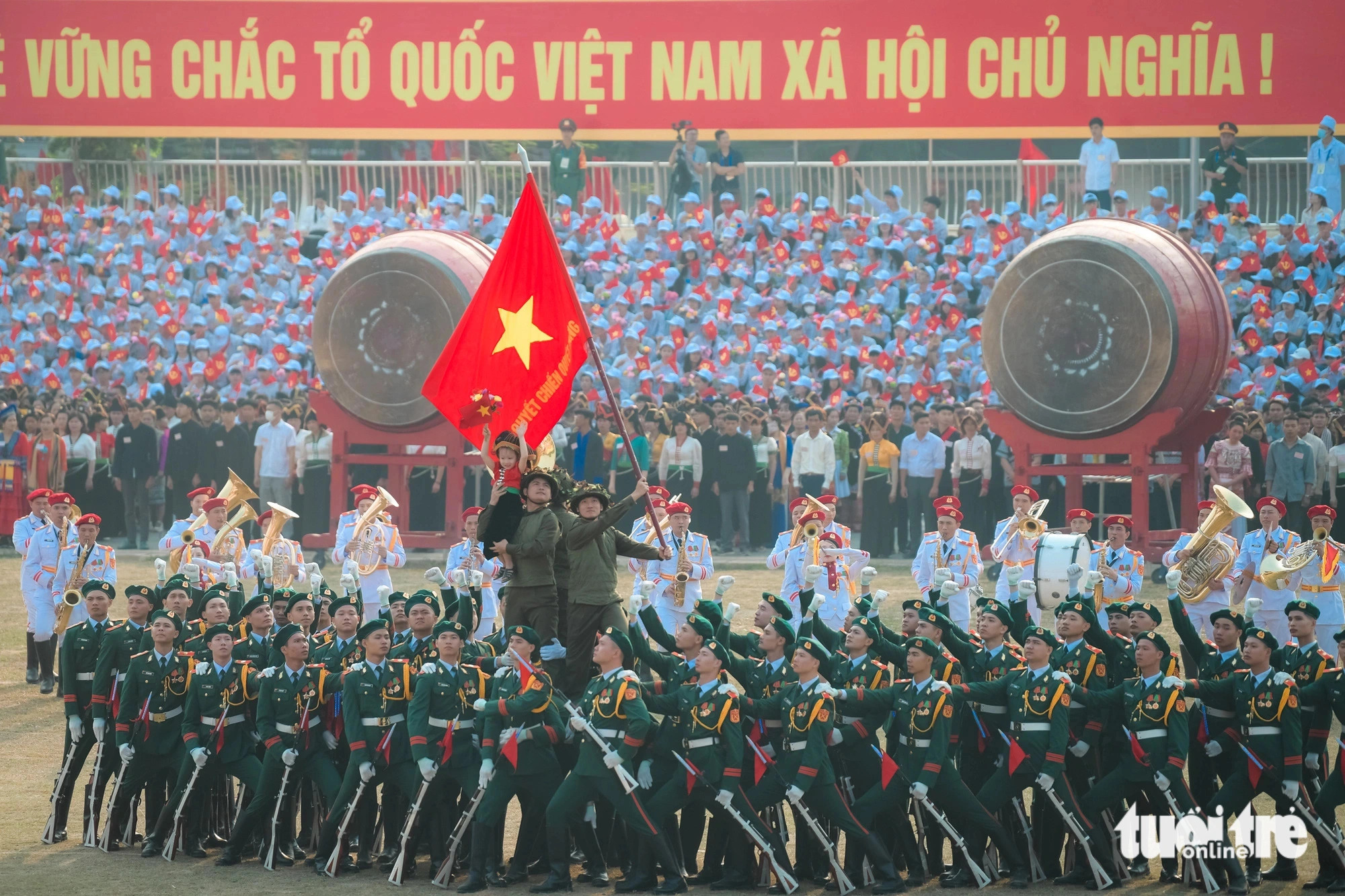 Vietnamese soldiers and a local child take part in a rehearsal for the upcoming 70th anniversary of the Dien Bien Phu Victory, Dien Bien Province, northwestern Vietnam, May 5, 2024. Photo: Nam Tran / Tuoi Tre