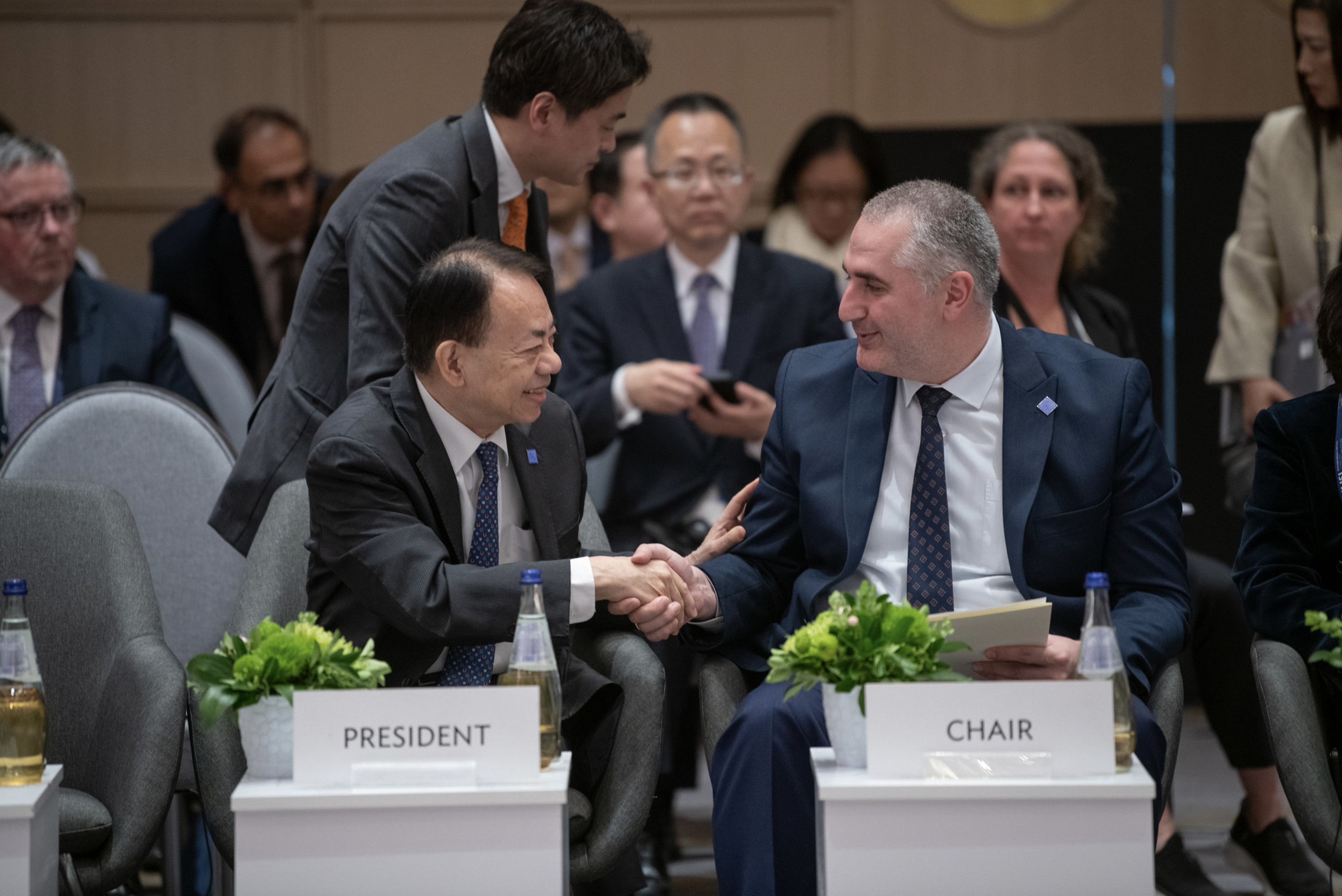 ADB president Masatsugu Asakawa (L) talks to a representative at a session of the 57th Annual Meeting held in Georgia on May 4, 2024. Photo: ADB