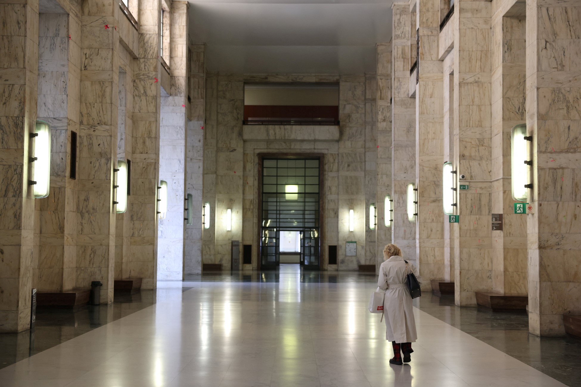 A woman walks along a corridor at Milan Court of Justice, in Milan, Italy, April 26, 2024. Photo: Reuters