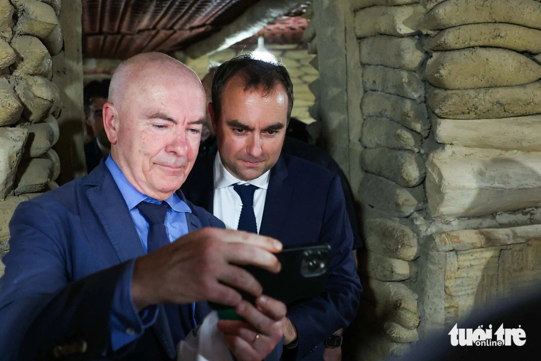 French Minister of Armed Forces Sébastien Lecornu (R) and another French official are seen when the latter was taking photos inside the bunker of late French General De Castries’ bunker in Dien Bien Phu City, Bien Bien Province, northern Vietnam on May 6, 2024. Photo: Nguyen Khanh / Tuoi Tre