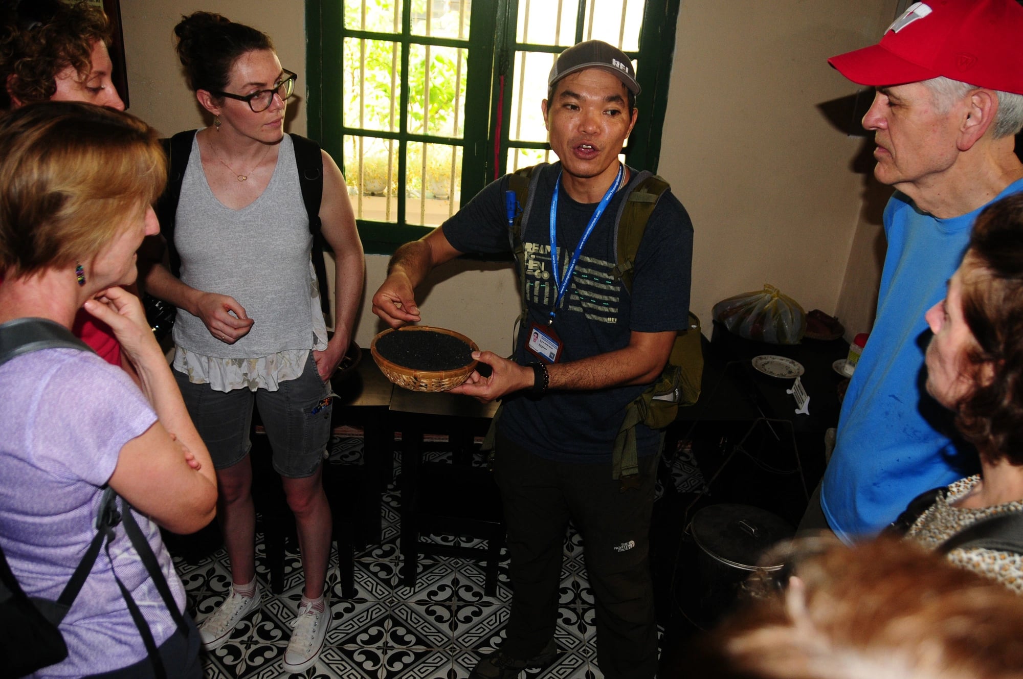 A guide (centered) introduces the process of making black sesame soup to a group of foreign tourists while they are visiting a workshop in Hoi An City, Quang Nam Province, central Vietnam. Photo: B.D./ Tuoi Tre