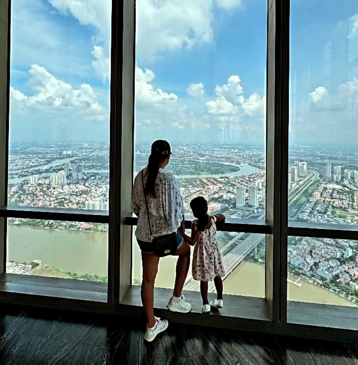 The Das family from the UK marvel at the Landmark 81 skyscraper in Ho Chi Minh City. Photo: Viola Das