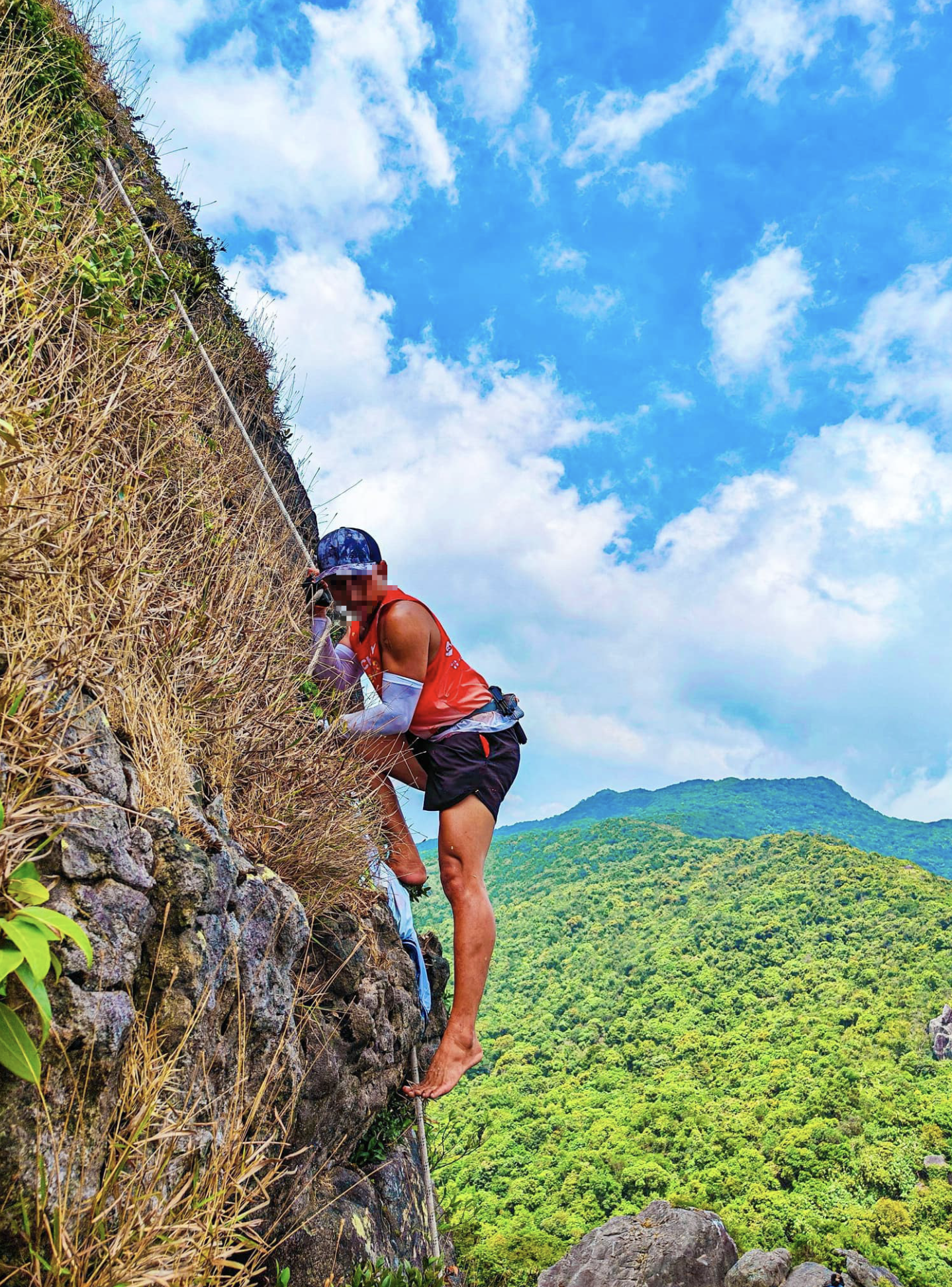 A man scales a vertical mountain without safety harnesses in Binh Dinh Province, south-central Vietnam. Photo: Facebook