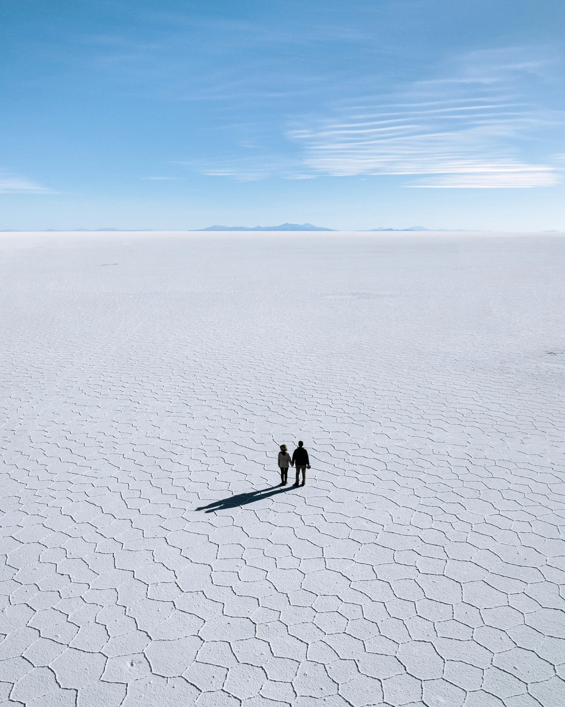 Vietnamese man Ngo Quang Dung and his Japanese wife are seen in a salt field of Uyuni, a city in Bolivia. Photo: Supplied.
