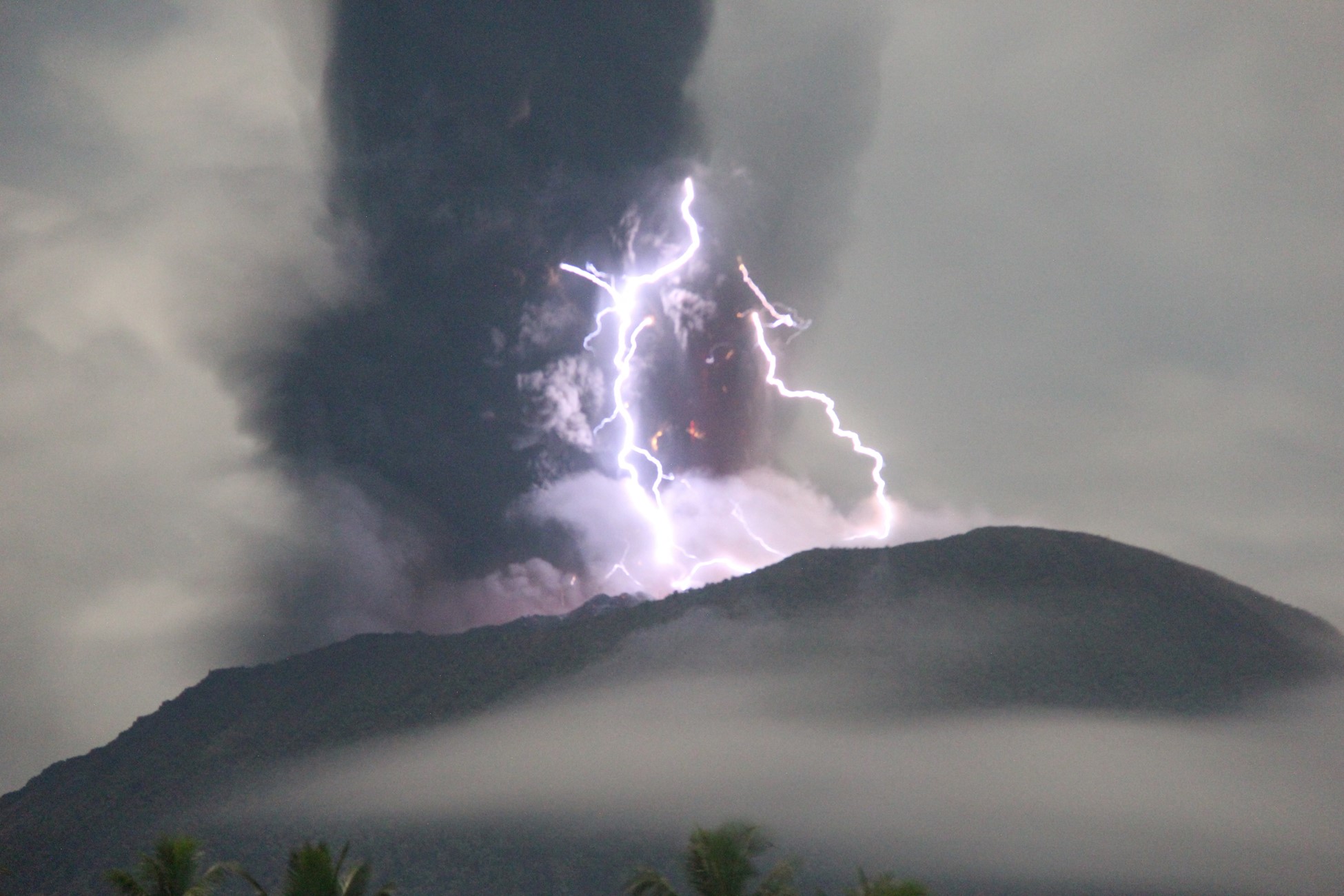 Lightning appears amid a storm as Mount Ibu spews volcanic material during an eruption, as seen from Gam Ici in West Halmahera, North Maluku province, Indonesia, May 18, 2024 in this handout image.