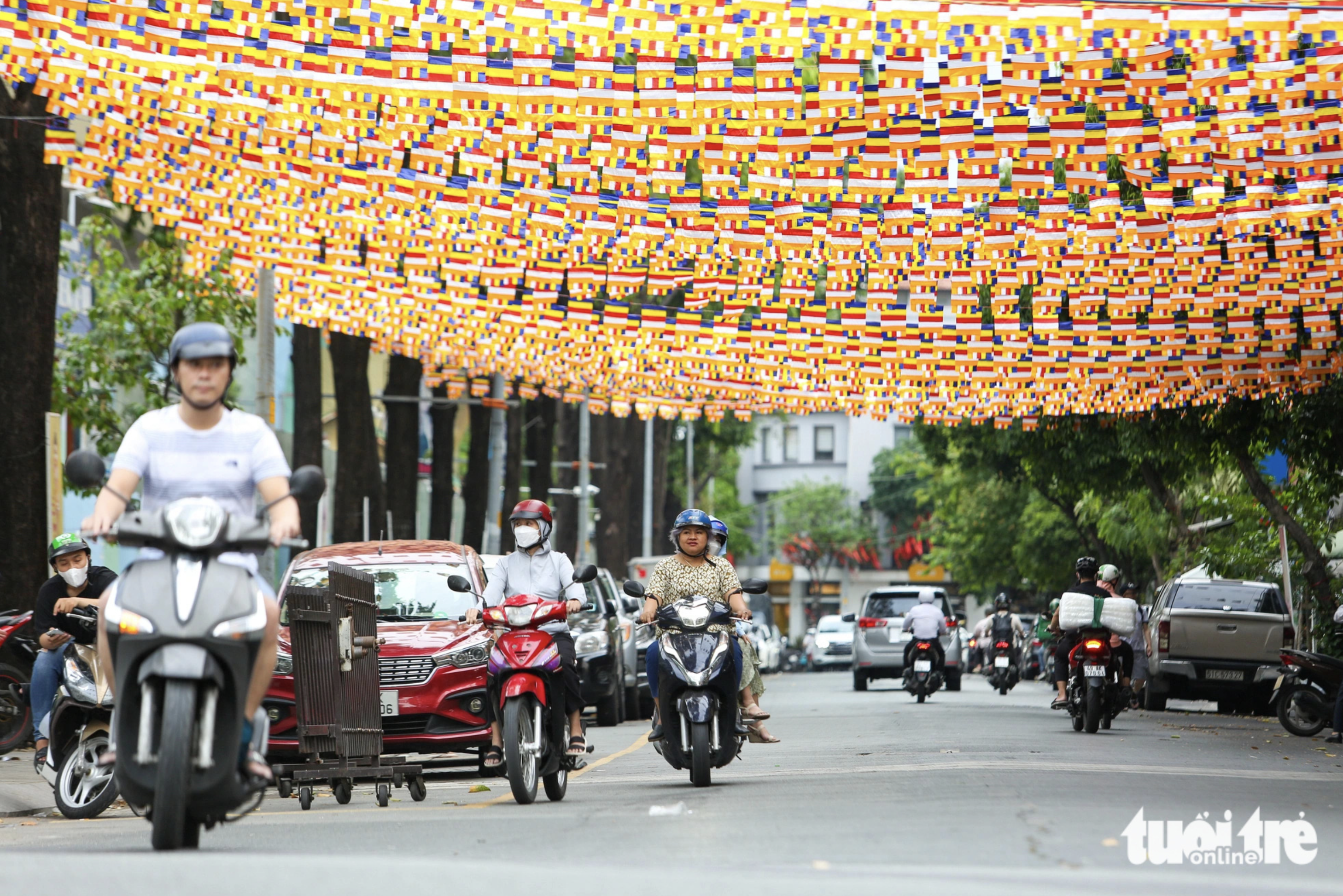 A street in Ho Chi Minh City is strung with Buddhist flags. Photo: Phuong Quyen / Tuoi Tre