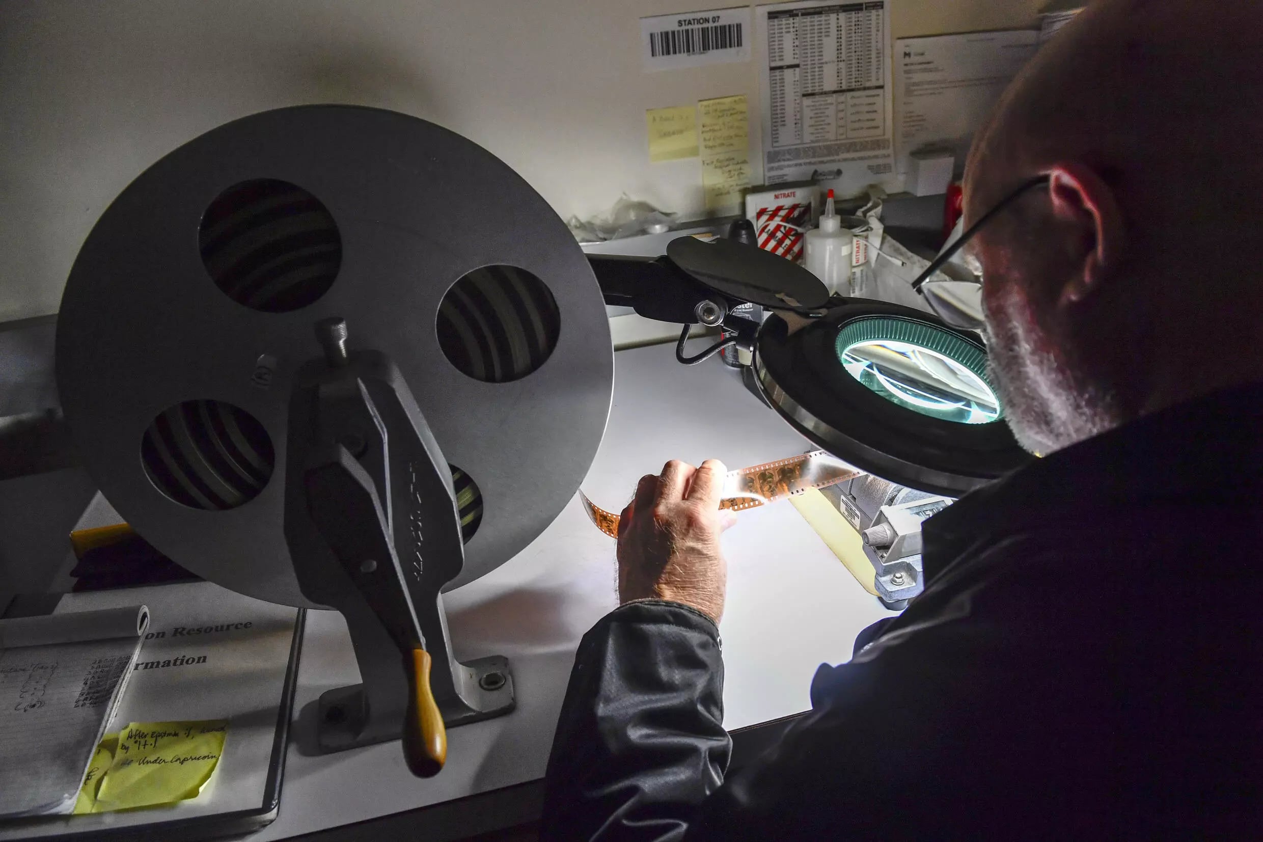 Before being stored, films have to be inspected frame by frame to ensure there is no damag. Photo: AFP