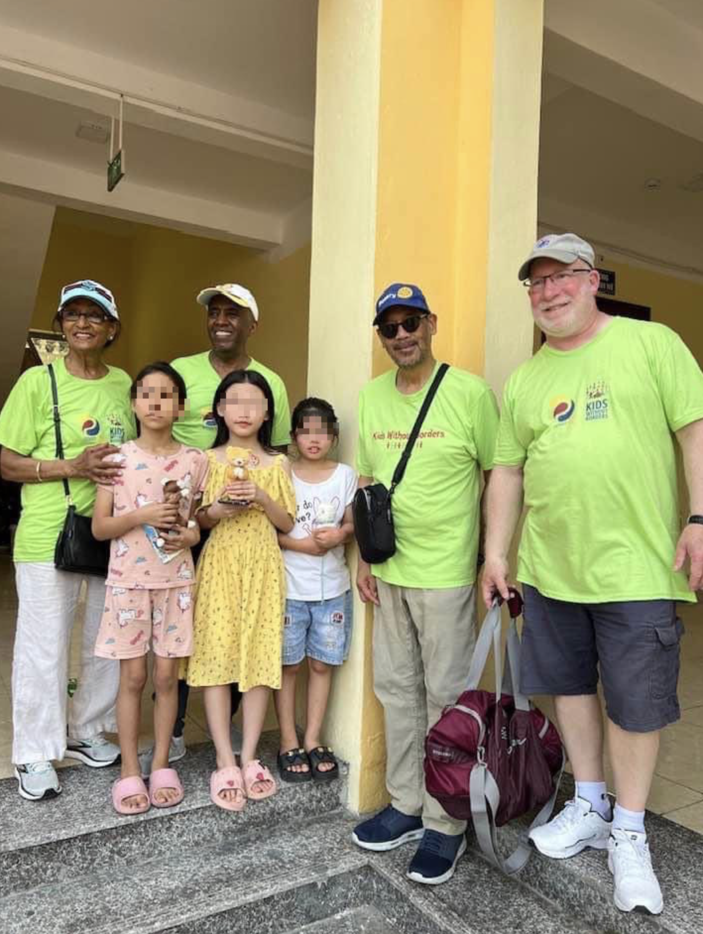 Ezra Teshome, an American, (left, 2nd) and other Rotary members pose for a photo with children at an orphanage in Hai Phong City. Supplied