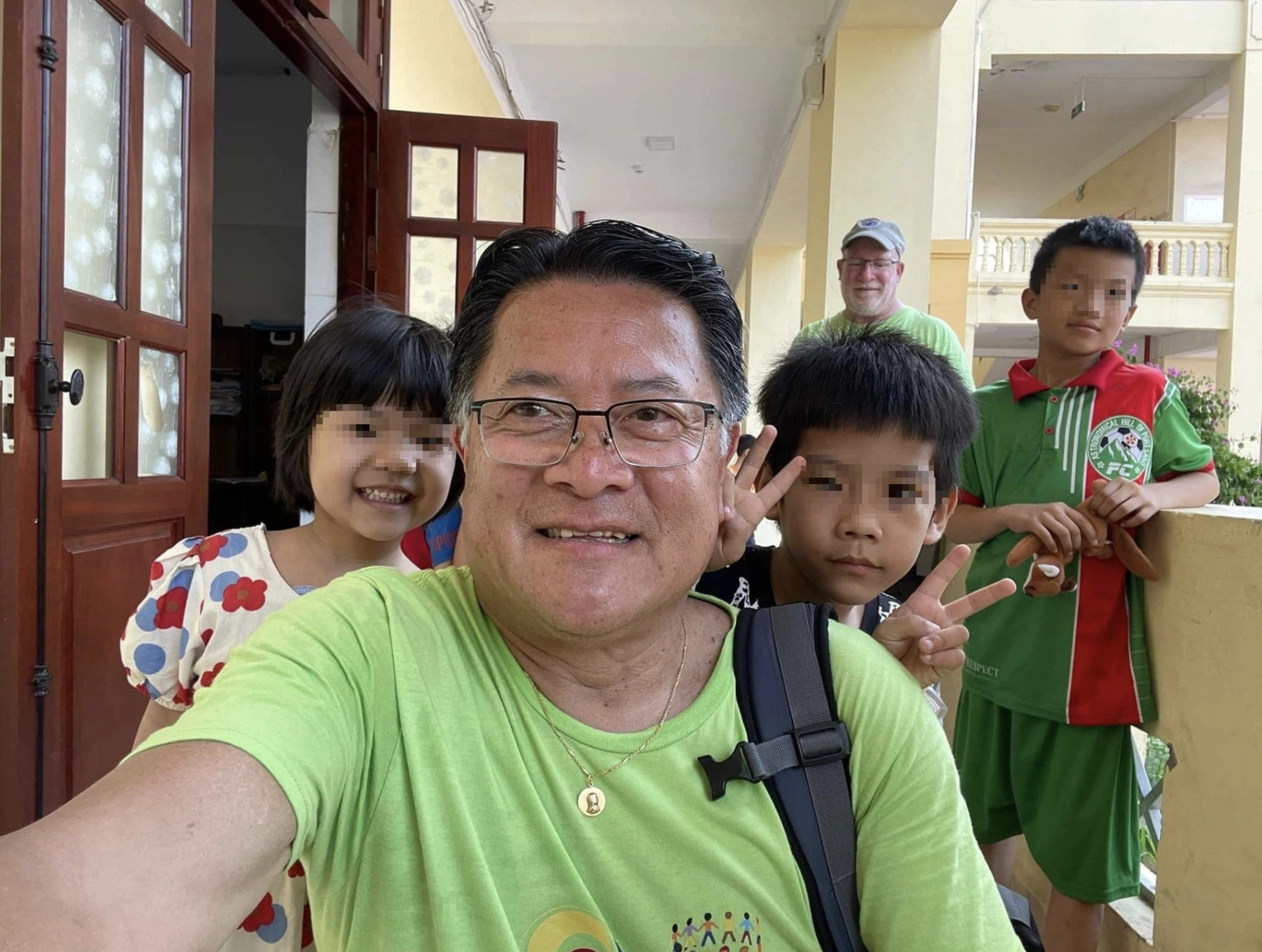 Son Michael Pham, leader of a group of members from Rotary International and Kids Without Borders, takes a wefie with children at an orphanage in Hai Phong City. Photo: Supplied