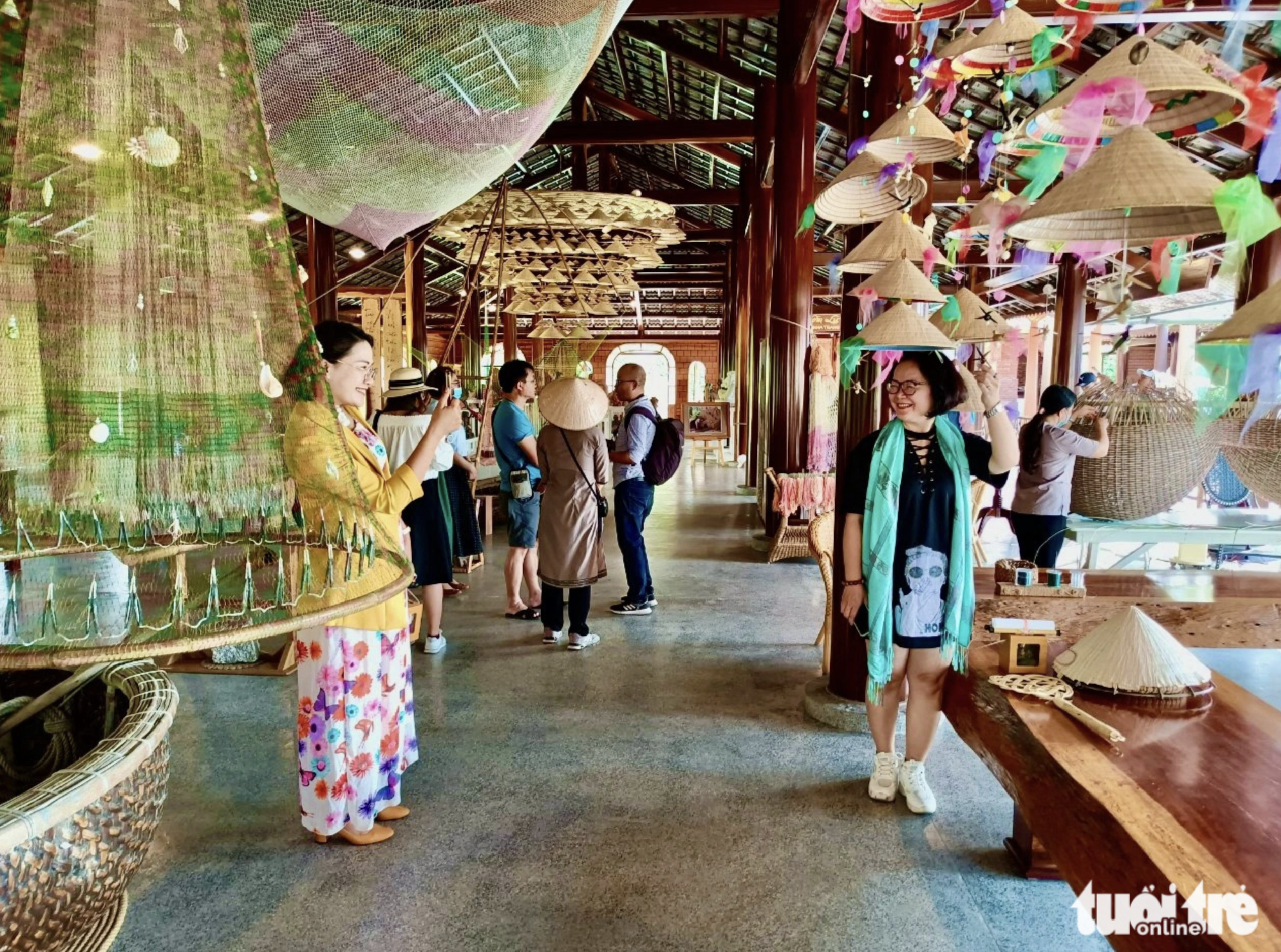 Tourists visit a traditional craft village festooned with decorations made of green materials in Khanh Hoa Province, south-central Vietnam. Photo: Minh Chien / Tuoi Tre