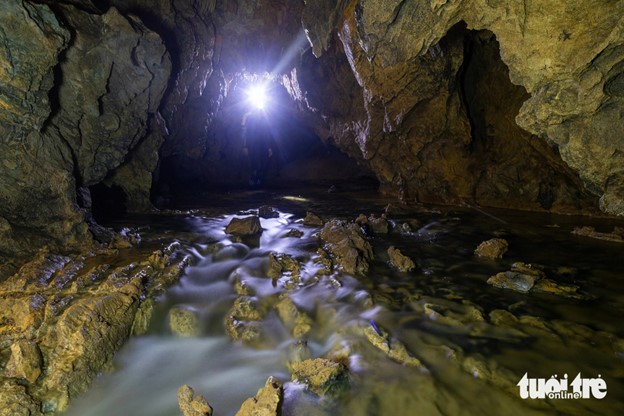 An underground river in Van Tien Cave connects two large lakes. Photo: Hoang Tao / Tuoi Tre