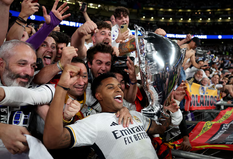 Soccer Football - Champions League - Final - Borussia Dortmund v Real Madrid - Wembley Stadium, London, Britain - June 1, 2024 Real Madrid's Rodrygo celebrates with a balloon trophy and the fans after winning the Champions League final. Photo: Reuters