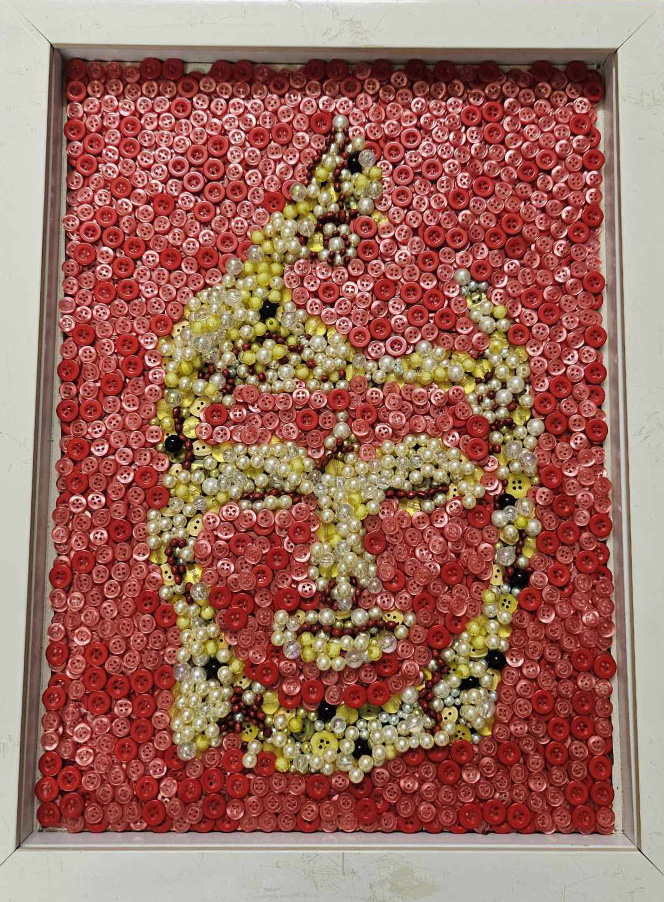 An artwork made by Nguyen Phuoc Quy Thanh using old shirt buttons features Buddha.
