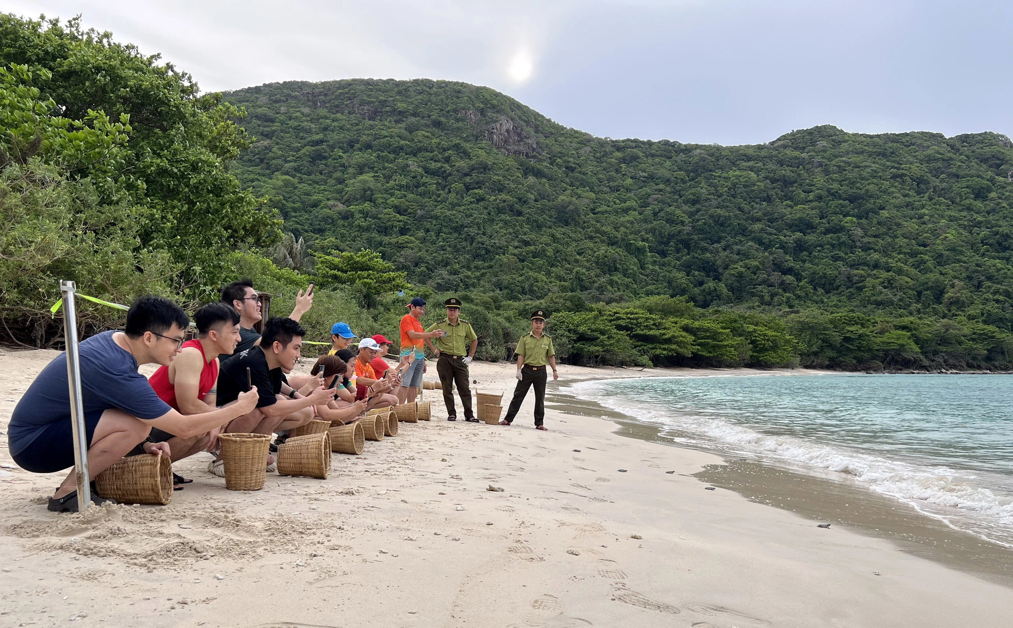 Young people enjoy releasing baby olive ridley sea turtles into the sea. Photo: N.D.K