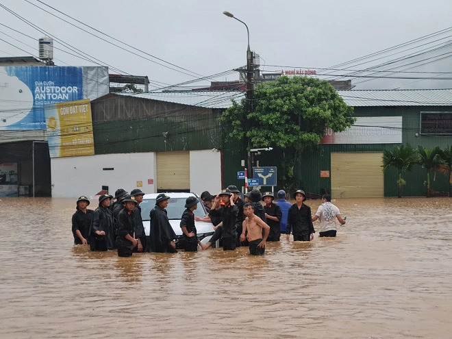A car stuck in a heavily-flooded street is evacuated in Ha Giang Province, northern Vietnam. Photo: Supplied
