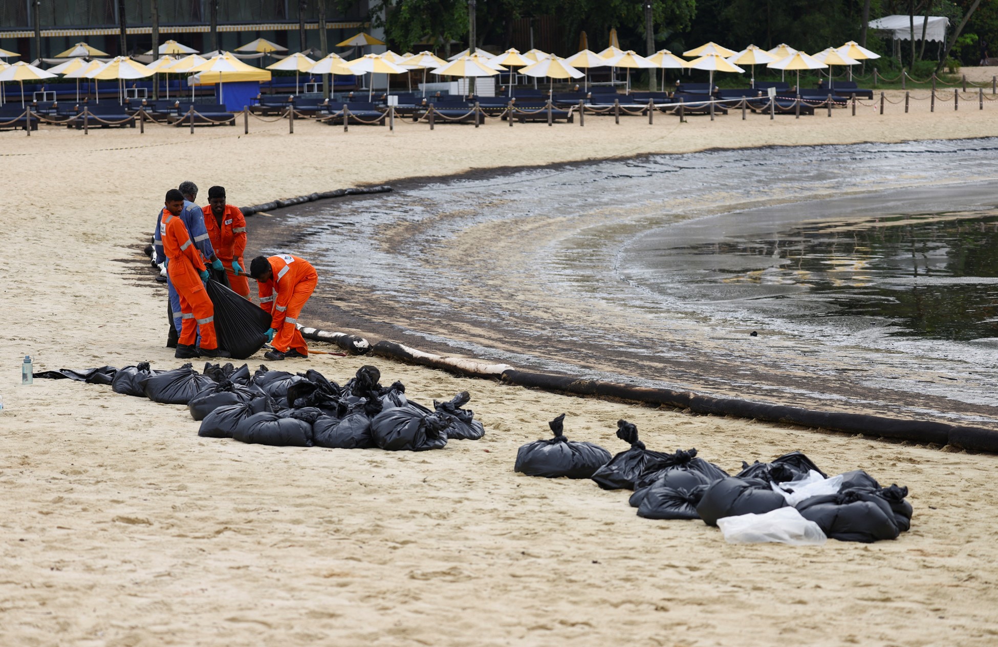 Singapore intensifies oil spill clean up after it spreads along coast