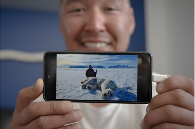 Hunter Martin Madsen shows the last polar bear he killed this year in April before reaching the annual quota.