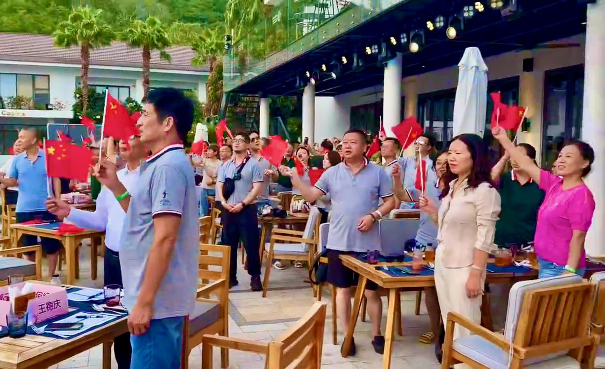 Travel firm fined for letting Chinese tourists wave flags while singing in performance