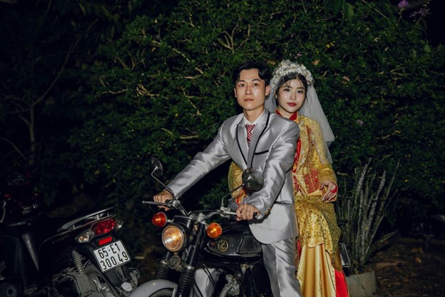 The groom used a motorcycle from the 1990s in their wedding procession ceremony. Photo: Supplied