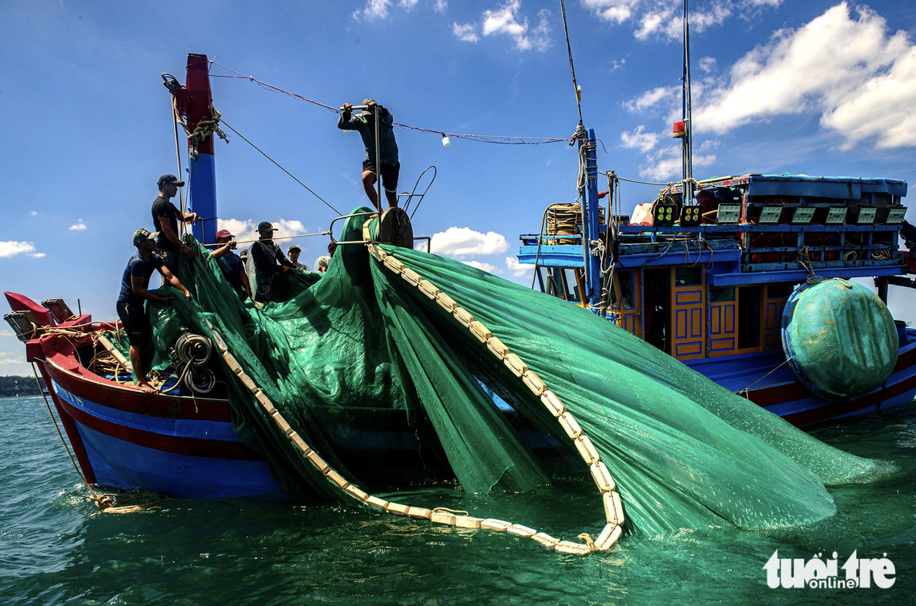 Fishermen pull back a net to collect anchovies in the waters off Phu Yen Province, south-central Vietnam.