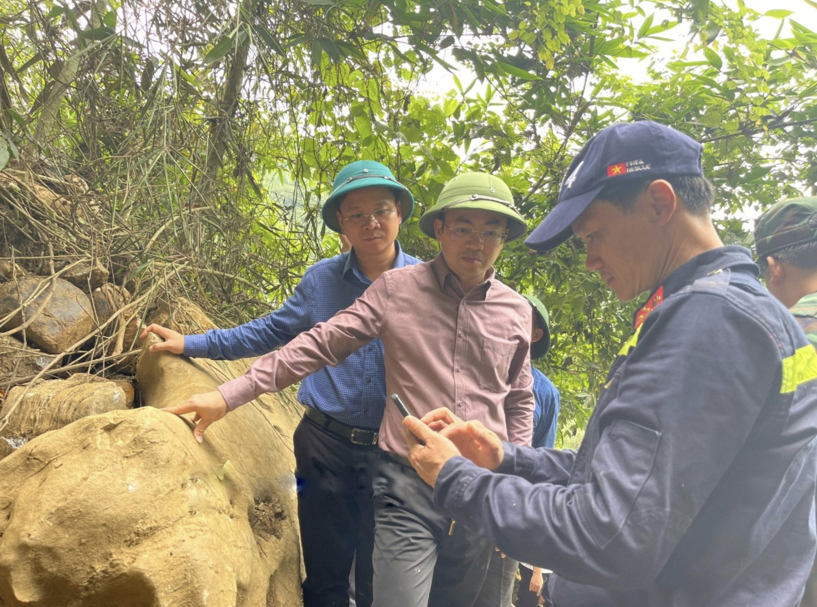 Officials and rescuers consider ways to identify the location of a person trapped inside a collapsed cave in Bac Kan Province, northern Vietnam. Photo: Supplied