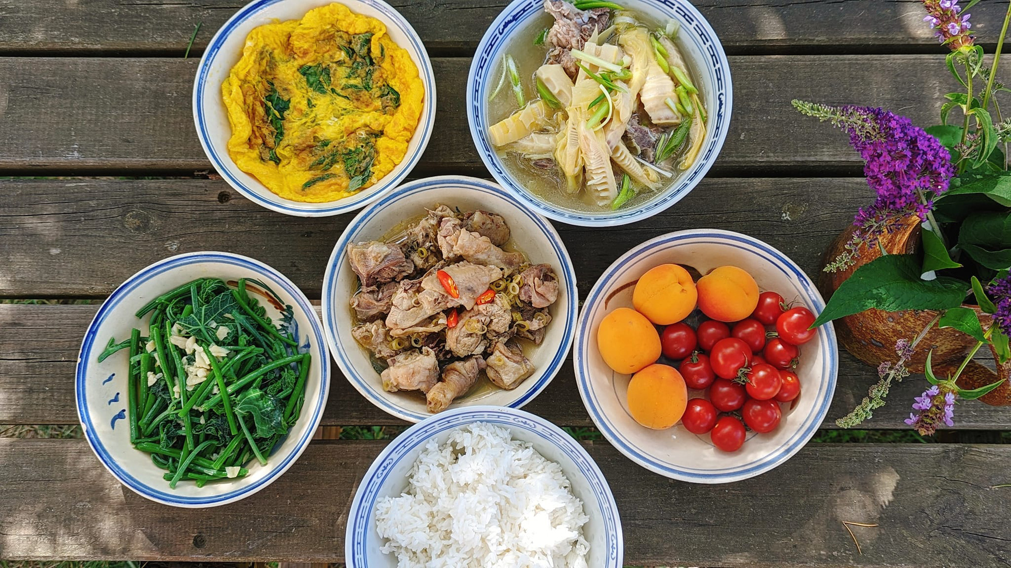 A meal containing bamboo shoot and bone soup, fried eggs with basil leaves, chayote vines stir-fried with garlic, and chicken stir-fried with lemongrass and chili prepared by Do Thuy Linh in France. Photo: Supplied