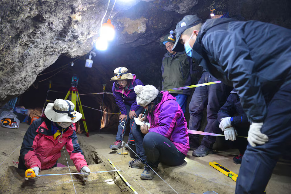 Scientists work inside Baishiya Karst Cave, where the remains of the extinct archaic human species called Denisovans as well as bones of blue sheep and various other animals have been discovered, on the northeastern edge of the Tibetan Plateau in China's Gansu province, in this undated handout photograph. Photo: Reuters