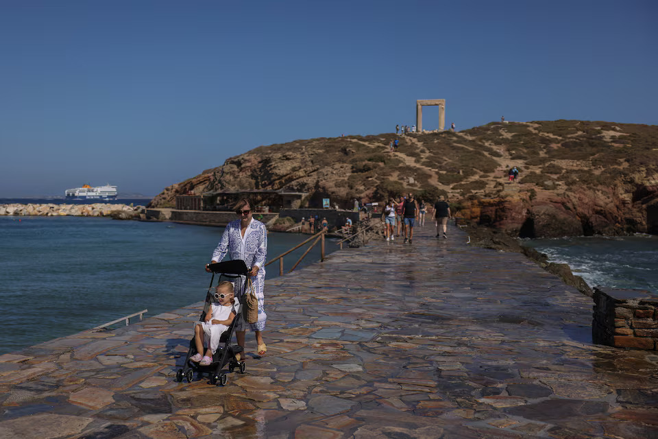 [9/10]Tourists visit the Great Door to the Temple of Apollo, known as Portara, on the island of Naxos, Greece, June 20, 2024. Photo: Reuters