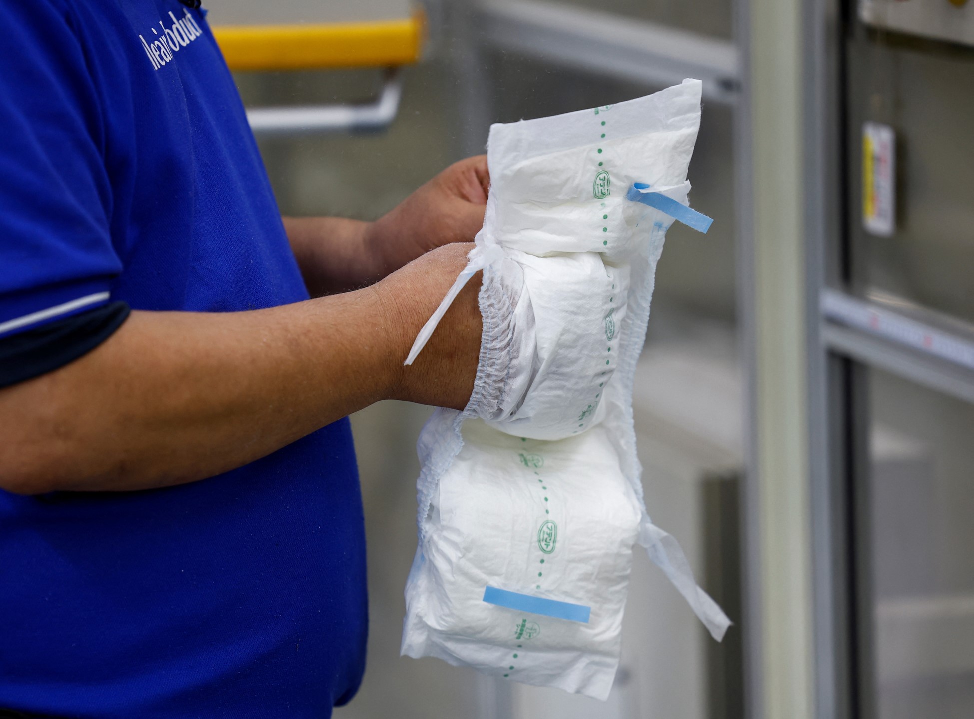 An employee works on an adult diaper production line at a factory of Daio Paper Corporation's subsidiary Elleair in Fujinomiya, Shizuoka prefecture, Japan June 18, 2024. Photo: Reuters