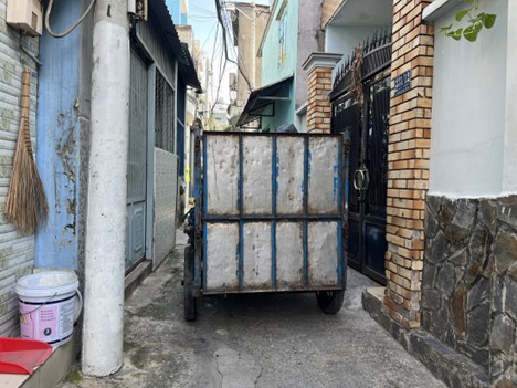 An alley on Kha Van Can Street in Ho Chi Minh City fits a small garbage vehicle.