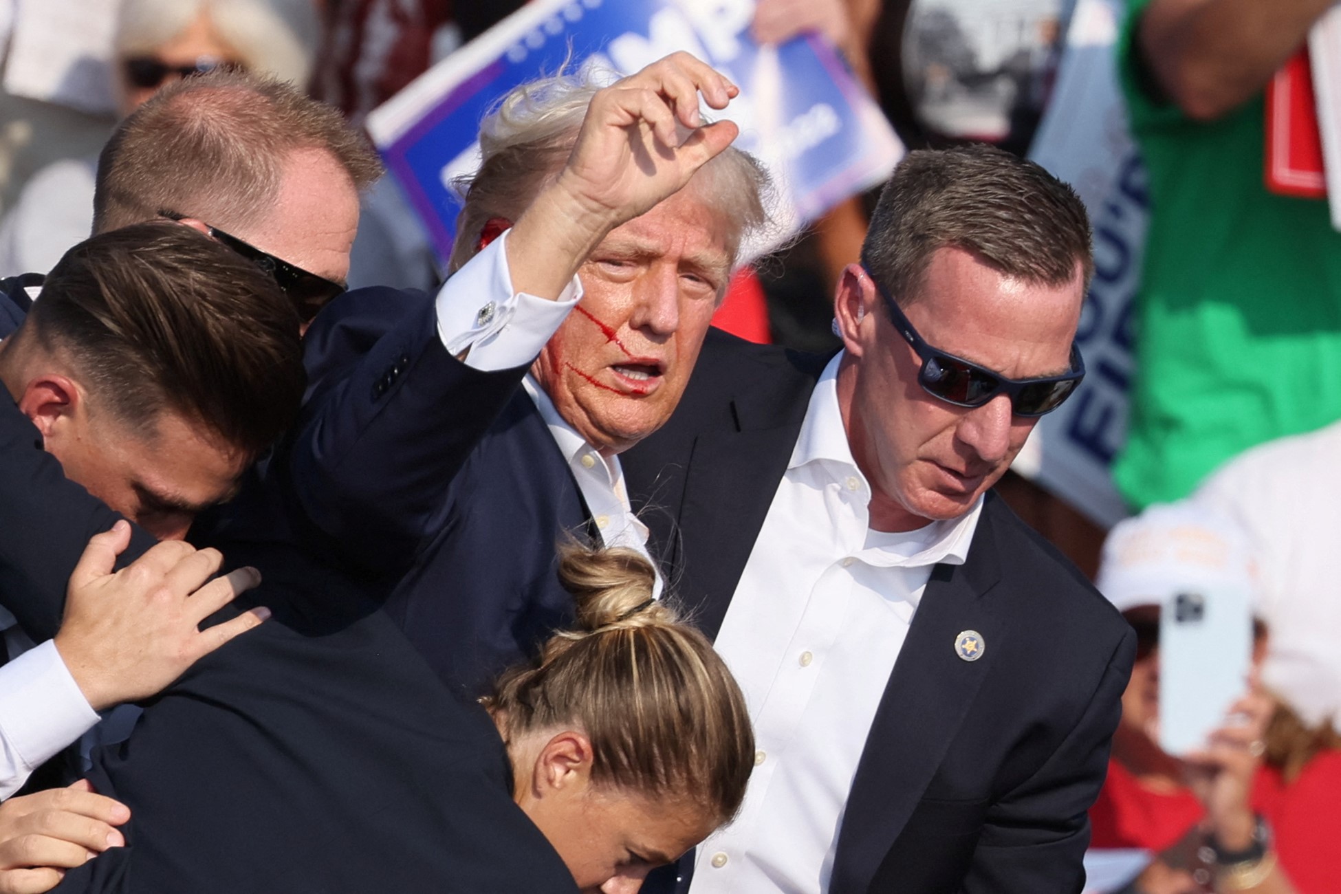 Republican presidential candidate and former U.S. President Donald Trump gestures with a bloodied face as multiple shots rang out during a campaign rally at the Butler Farm Show in Butler, Pennsylvania, U.S., July 13, 2024. Photo: Reuters