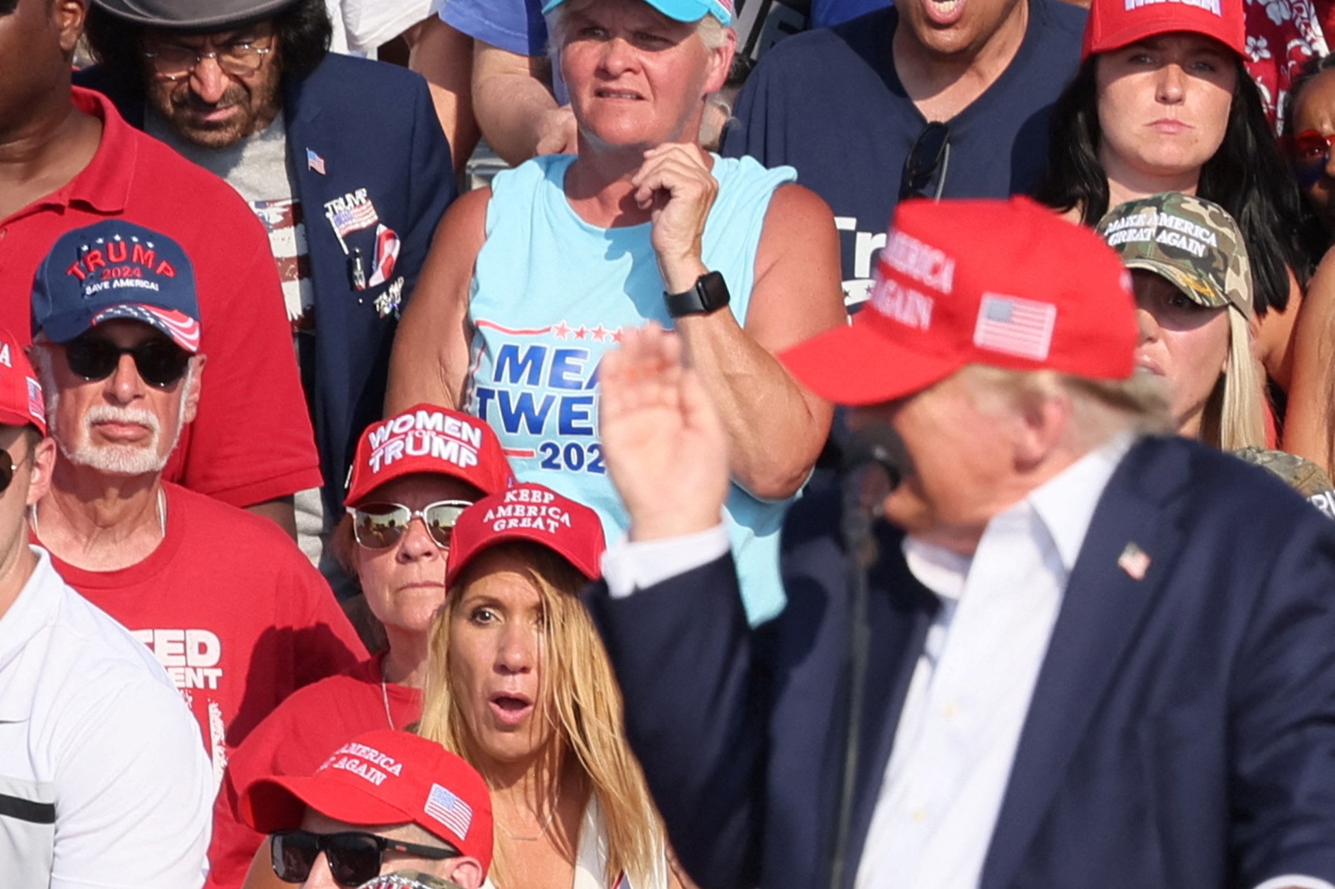 Republican presidential candidate and former U.S. President Donald Trump is assisted by security personnel after gunfire rang out during a campaign rally at the Butler Farm Show in Butler, Pennsylvania, U.S., July 13, 2024. Photo: Reuters