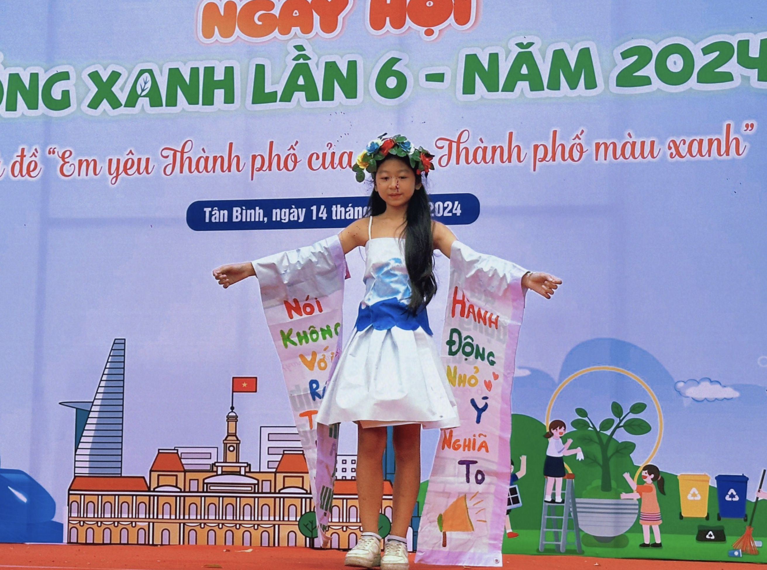 Children transform old paper and nylon into a dress. Photo: Supplied