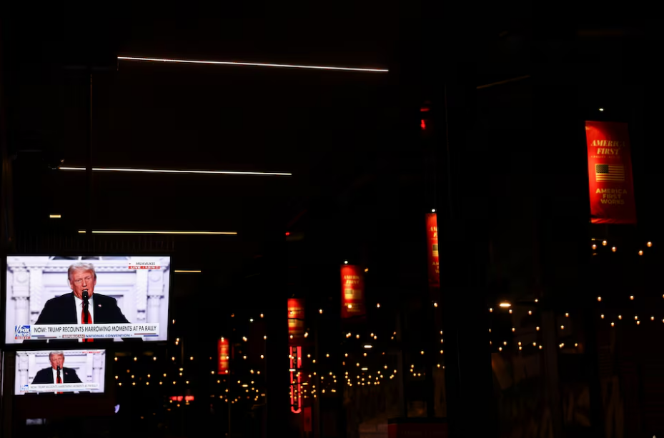 Screens display Republican presidential nominee and former U.S. President Donald Trump speaking on Day 4 of the Republican National Convention (RNC), at the Fiserv Forum in Milwaukee, Wisconsin, U.S., July 18, 2024. Photo: Reuters