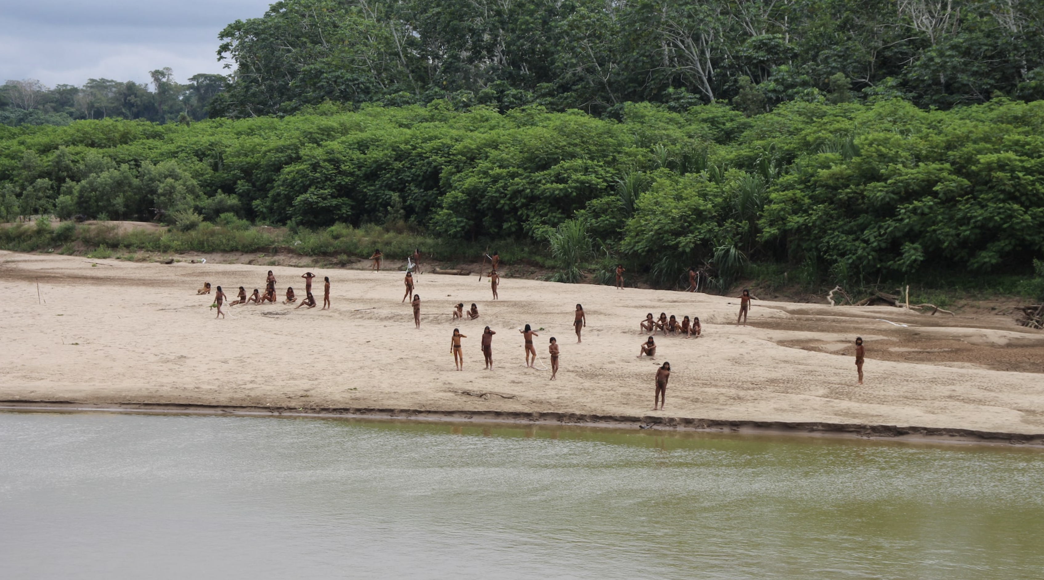 Members of the Mashco Piro Indigenous community, a reclusive tribe and one of the world's most withdrawn, stand on the banks of the Las Piedras river in Monte Salvado, in the Madre de Dios province, Peru, June 27, 2024. Photo: Reuters