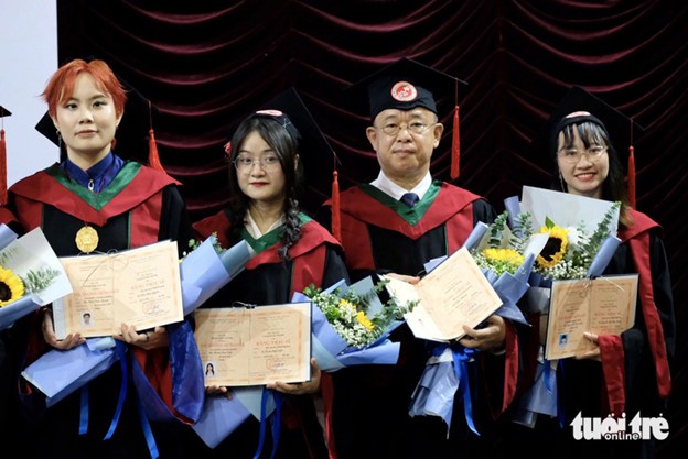 Kato (R, 2nd) and his classmates receive their master’s degrees. Photo: Nguyen Bao / Tuoi Tre