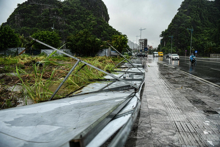 The metal fence surrounding a construction site in Ha Long City, Quang Ninh Province, northern Vietnam, falls due to the tropical depression that landed there on July 23, 2024. Photo: Nam Tran / Tuoi Tre