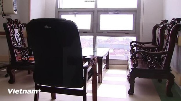 A wooden table and chairs are placed in the corridor outside the room of Party General Secretary Nguyen Phu Trong.