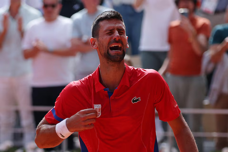 [4/6]Paris 2024 Olympics - Tennis - Men's Singles Gold Medal Match - Roland-Garros Stadium, Paris, France - August 04, 2024. Novak Djokovic of Serbia reacts after winning gold against Carlos Alcaraz of Spain. Photo: Reuters