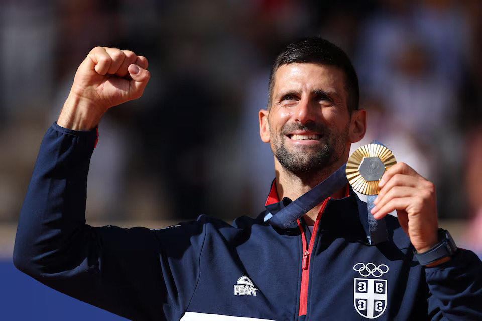 Paris 2024 Olympics - Tennis - Men's Singles Victory Ceremony - Roland-Garros Stadium, Paris, France - August 04, 2024. Gold medallist Novak Djokovic of Serbia poses with his medal. Photo: Reuters