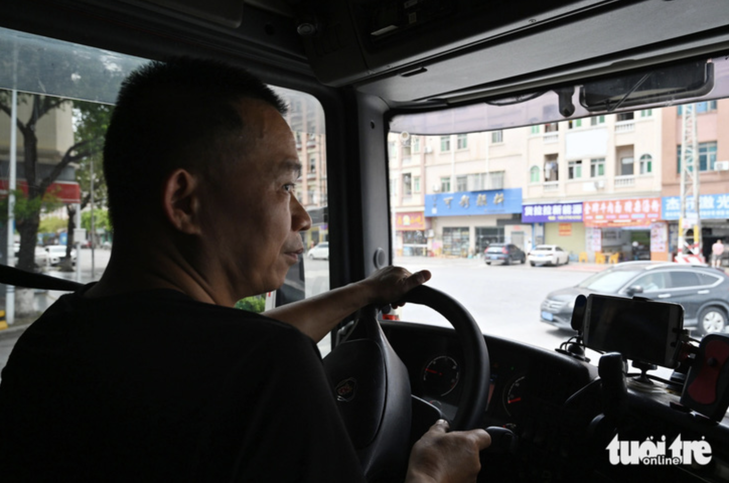 A Chinese driver who is in charge of transporting goods from a warehouse in Dongguan, China to the border area with Vietnam.